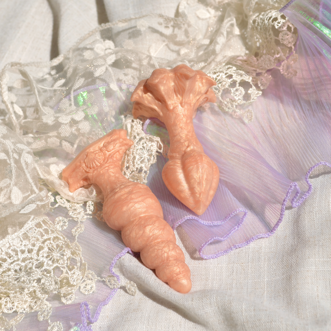 Comparaison de la base ronde du plug anal orange avec la base en T du sextoy Fênra