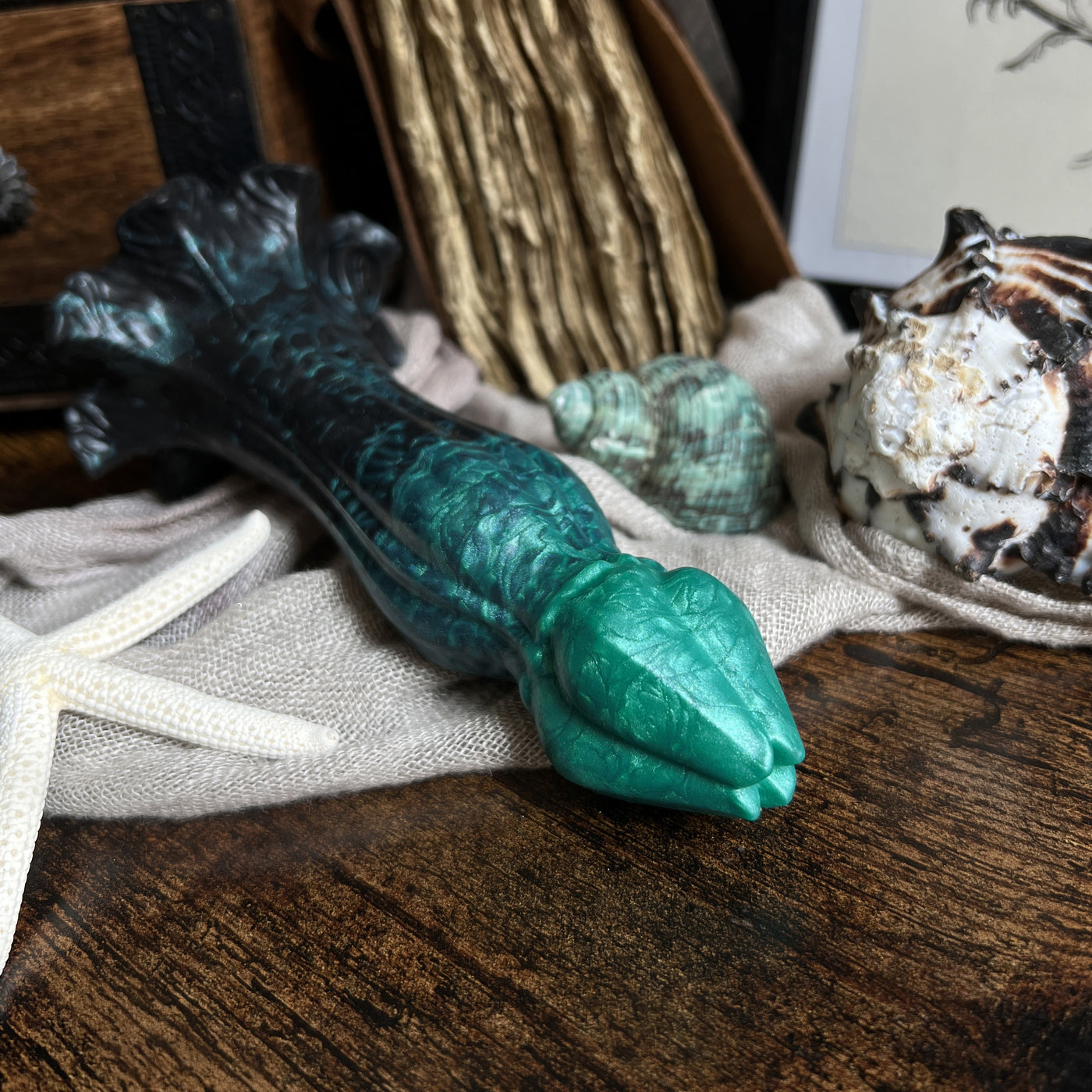 Sextoy noir et vert à l'atmosphère goth et dark academia, ce gode fantaisie en silicone a une texture souple et moelleuse